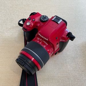 Pentax digital SLR camera and accessories. Red.